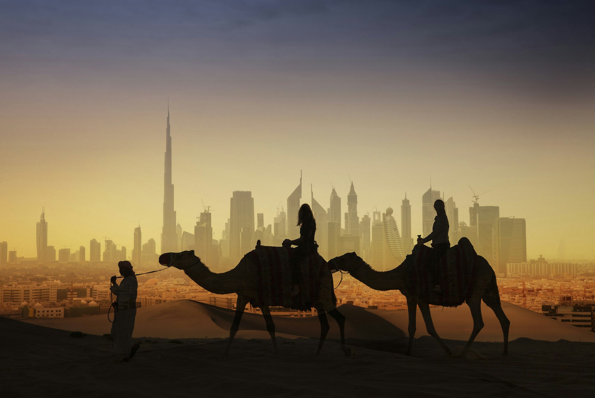 Riding camels in the desert outside Dubai, United Arab Emirates