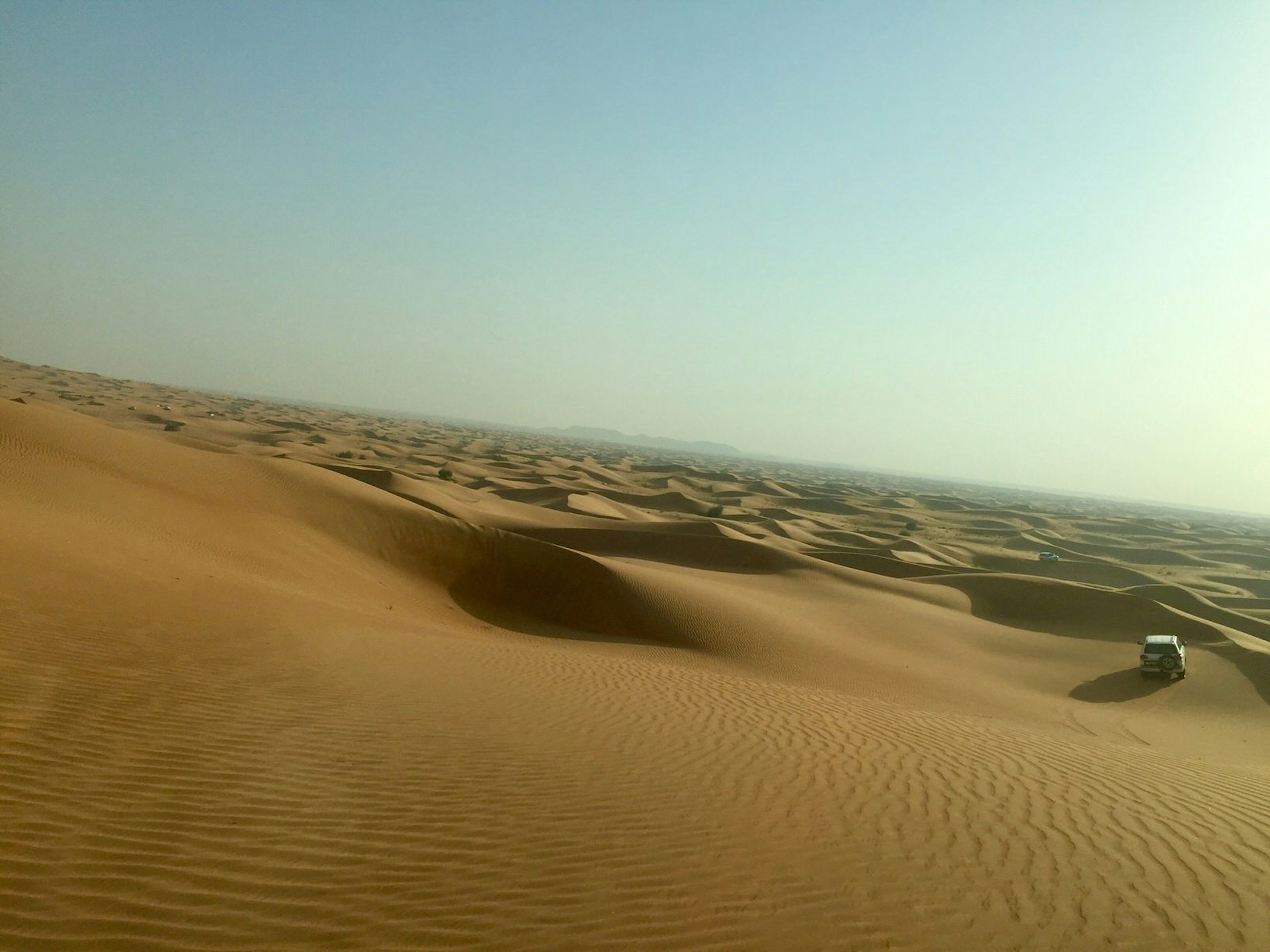 Driving through the desert sand dunes outside Dubai, United Arab Emirates