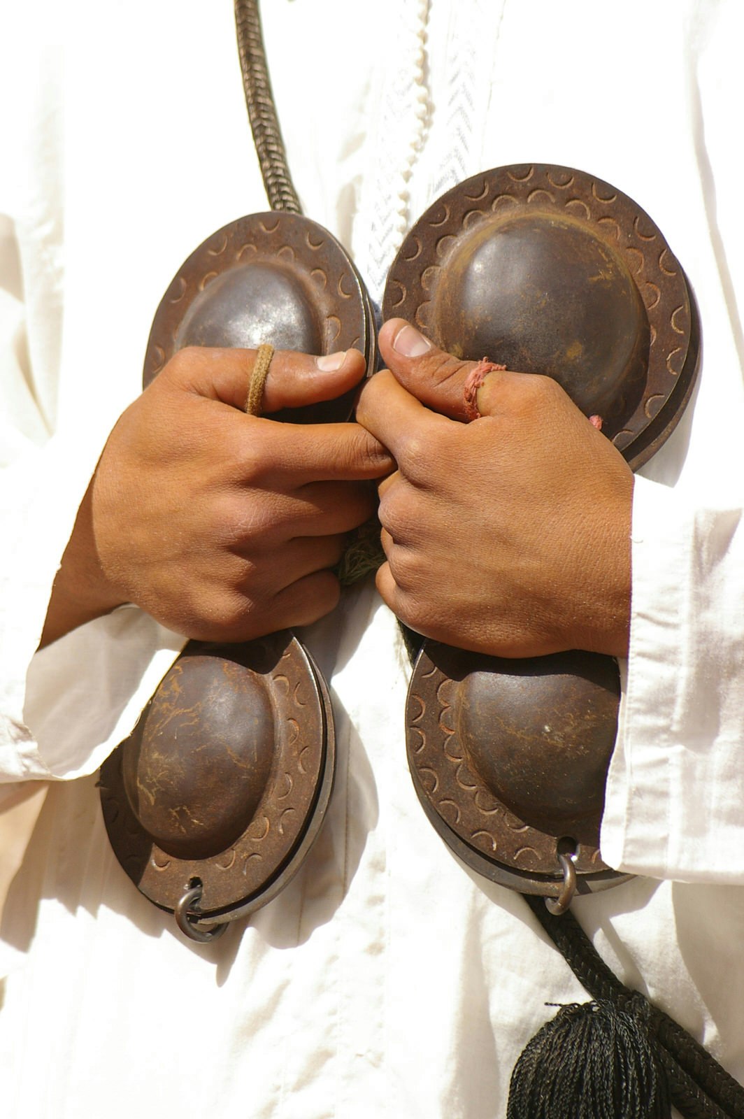 Close up of iron castanets, played by a musician at Essaouira's Gnaoua and World Music Festival. Image by Sallyrango / Getty