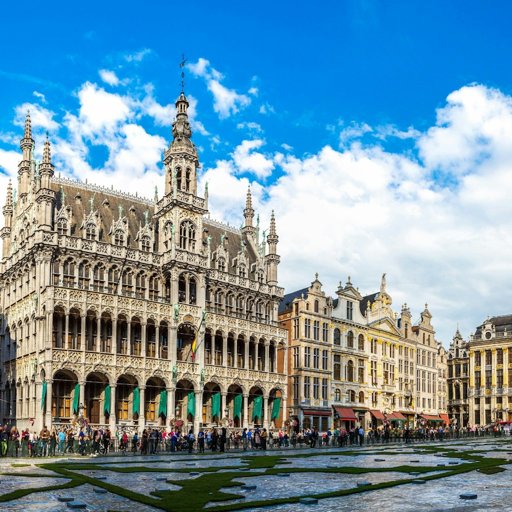 Features - The Grand Place in a beautiful summer day in Brussels, Belgium.