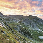 Switzerland's famed hairpin turns twist and turn up a mountain at sunset