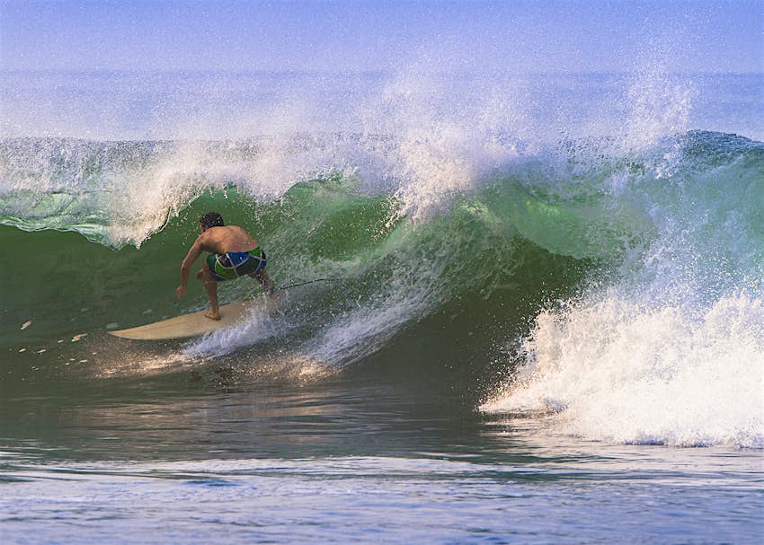 Features - surfing_elsalvador_Lonely_Planet.jpg A surfer catches a barrelling wave off the Pacific coast of El Salvador © VisualCommunications / Getty Images