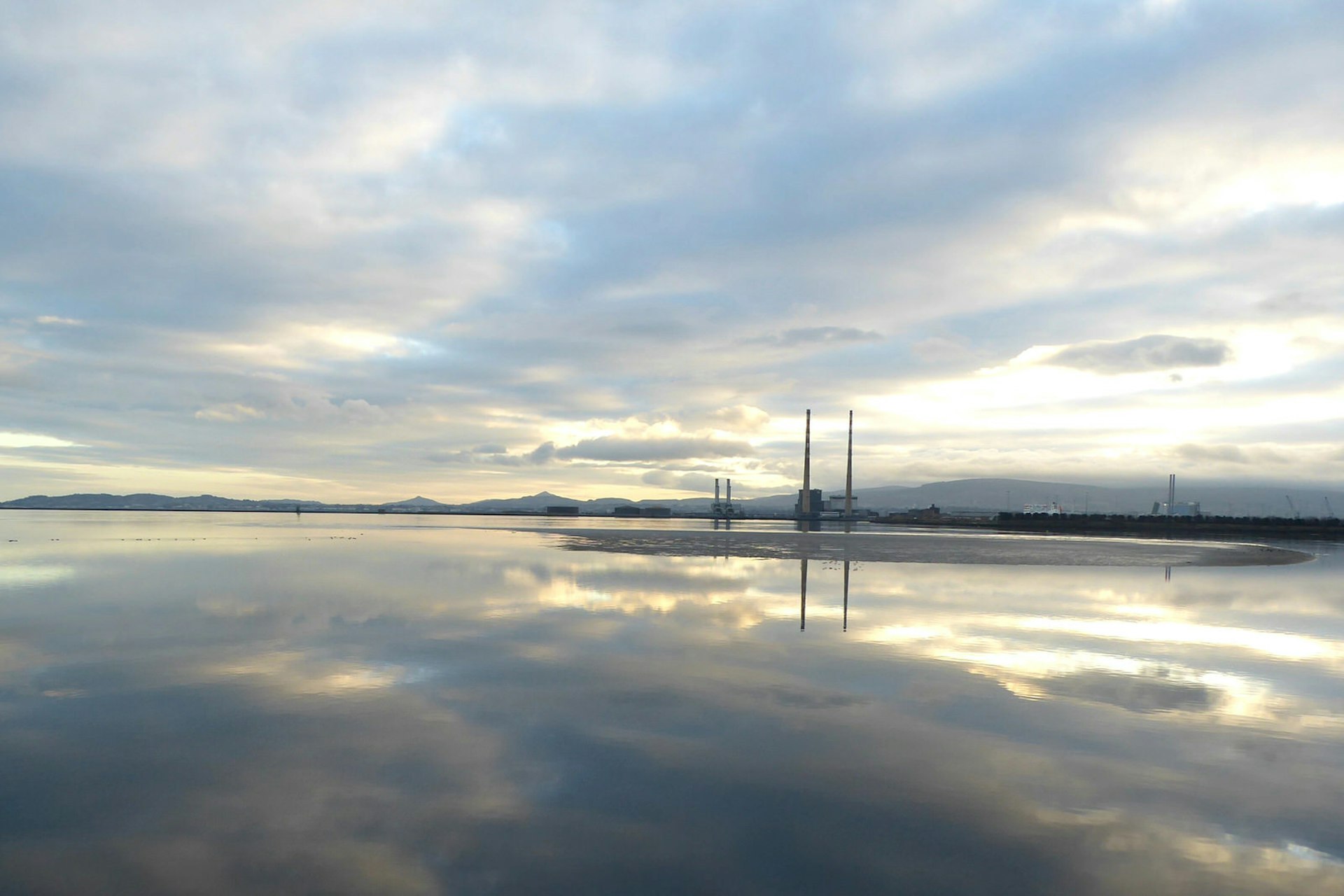 The beach at Dollymount Strand with some sunlight peeping through the clouds