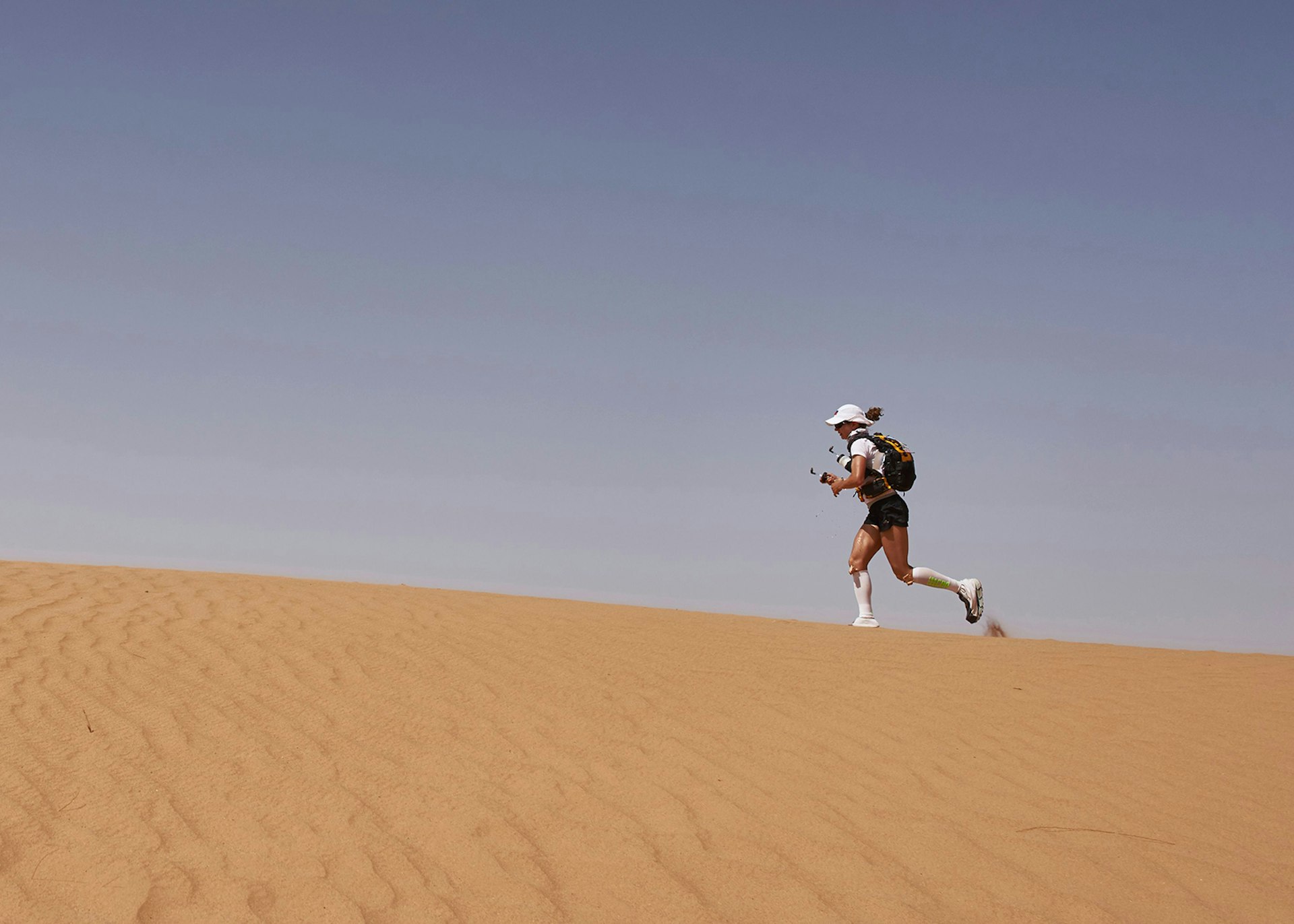 A competitor conquering a dune in the formidable Marathon des Sables, Morocco © Jean-Philippe Ksiazek / Getty Images