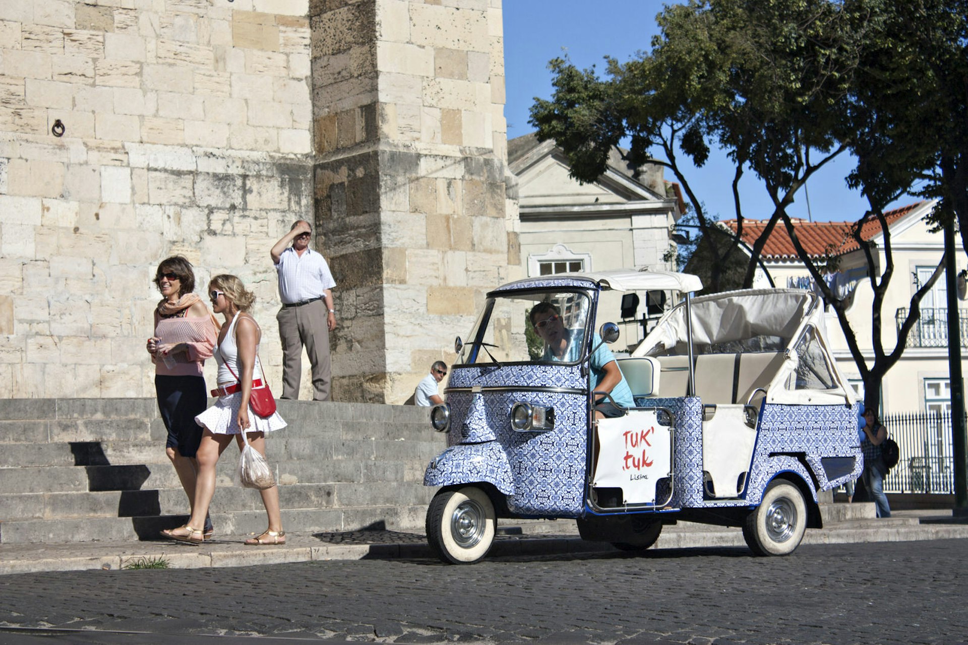 Urban transport in Lisbon: An e-tuk-tuk driver awaits his next passengers