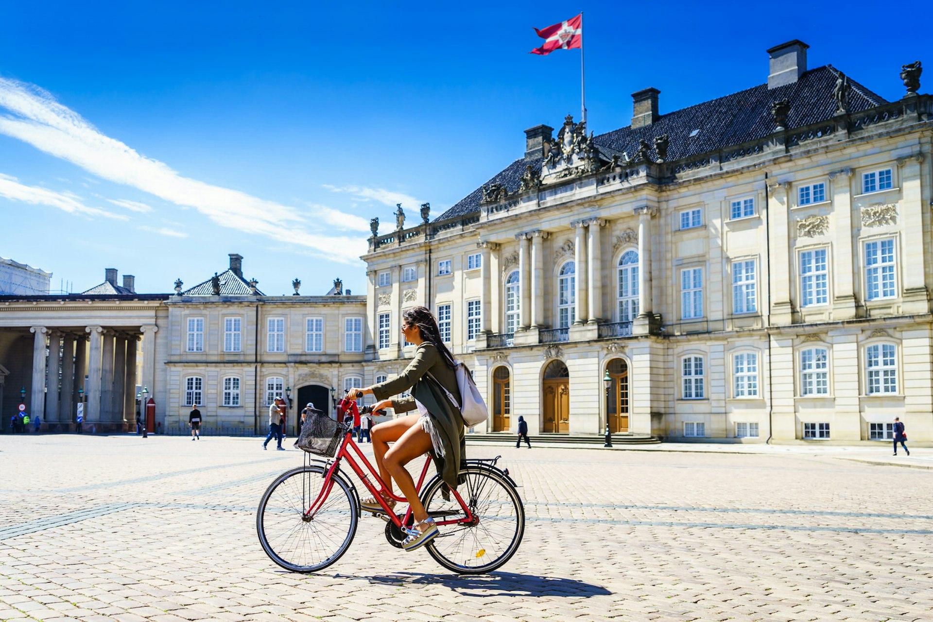 Urban transport in Copenhagen: A cyclist rides through Amalienborg Square