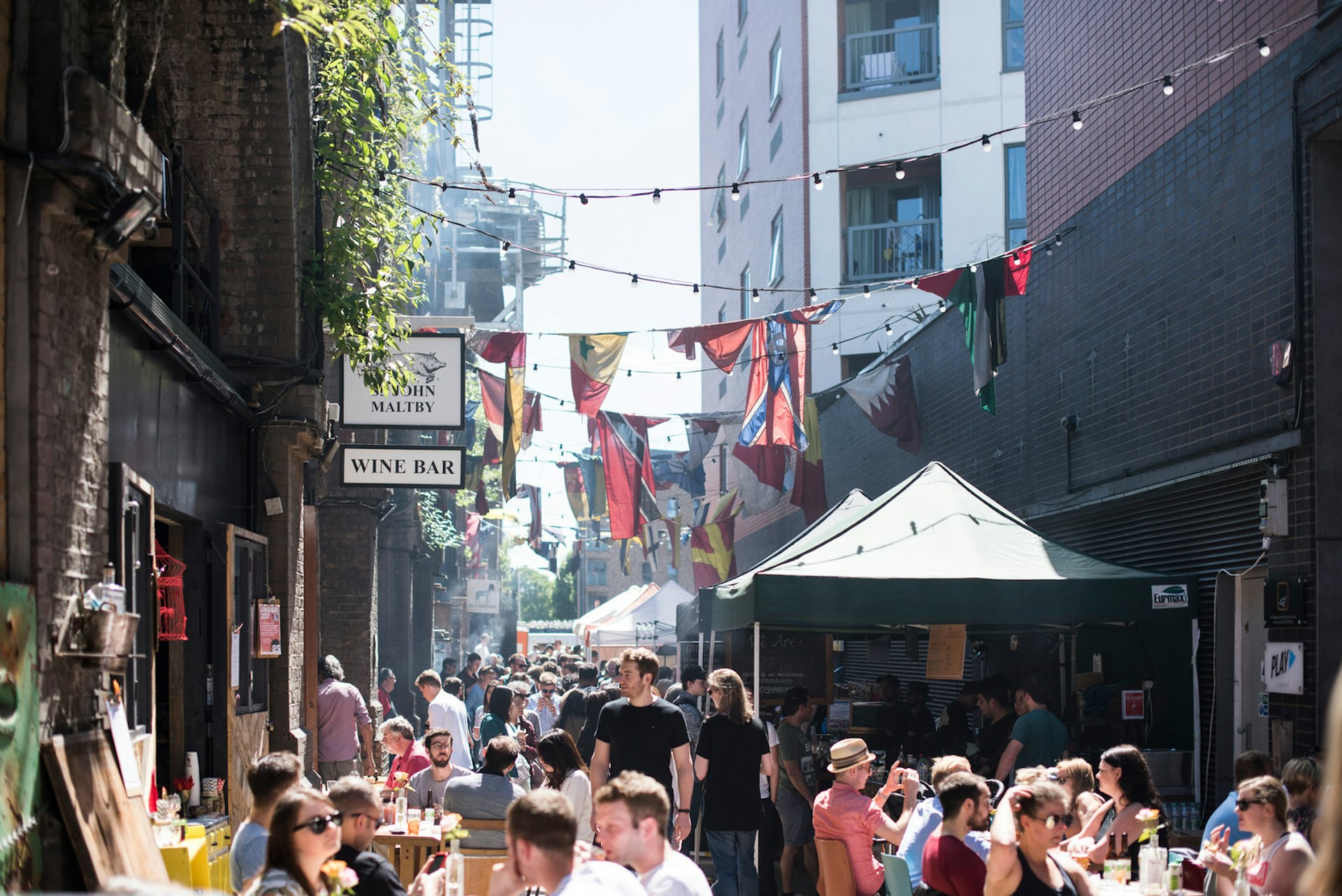 Food stalls and crowds of people at Maltby Street Market