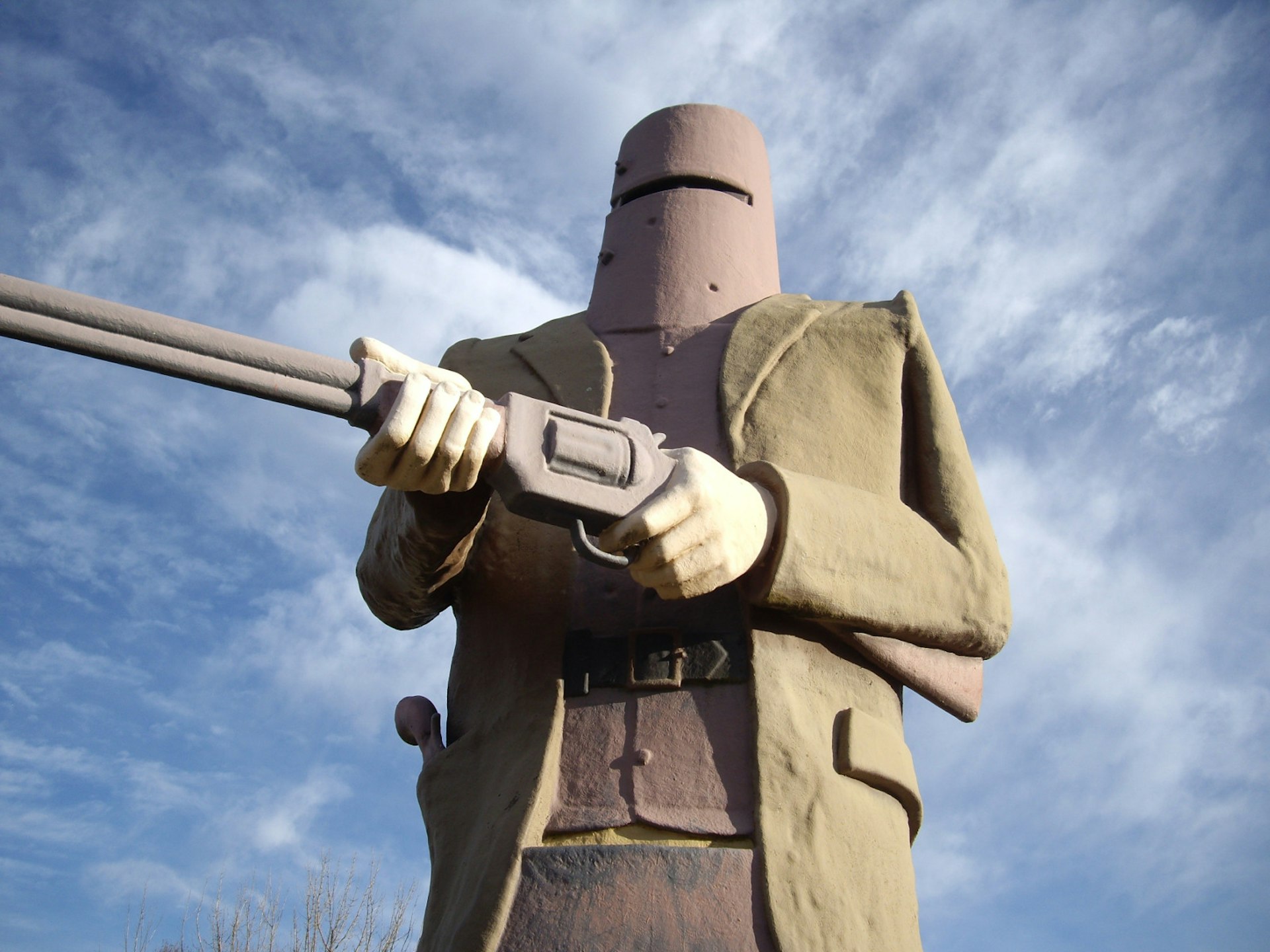 The monument of Ned Kelly wearing his bucket helmet and holding a shot gun at Glenrowan, Australia