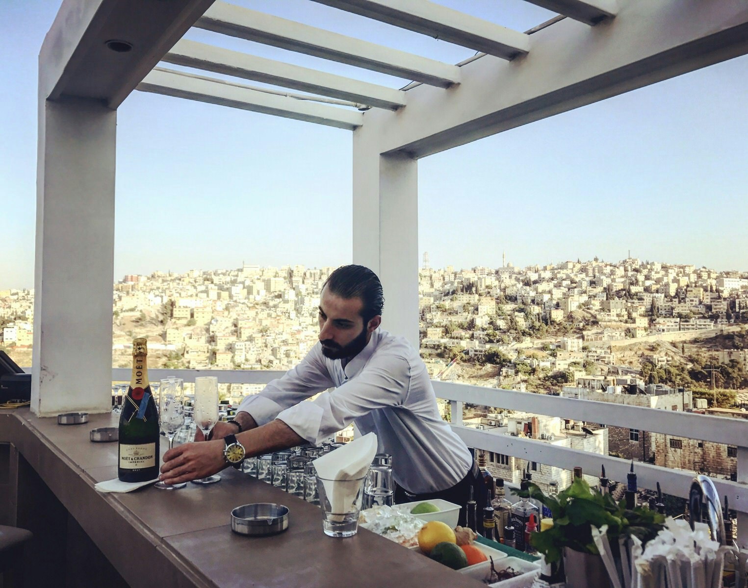 Bartender serves champagne at Cantaloupe in Amman. Image by Sunny Fitzgerald / Lonely Planet