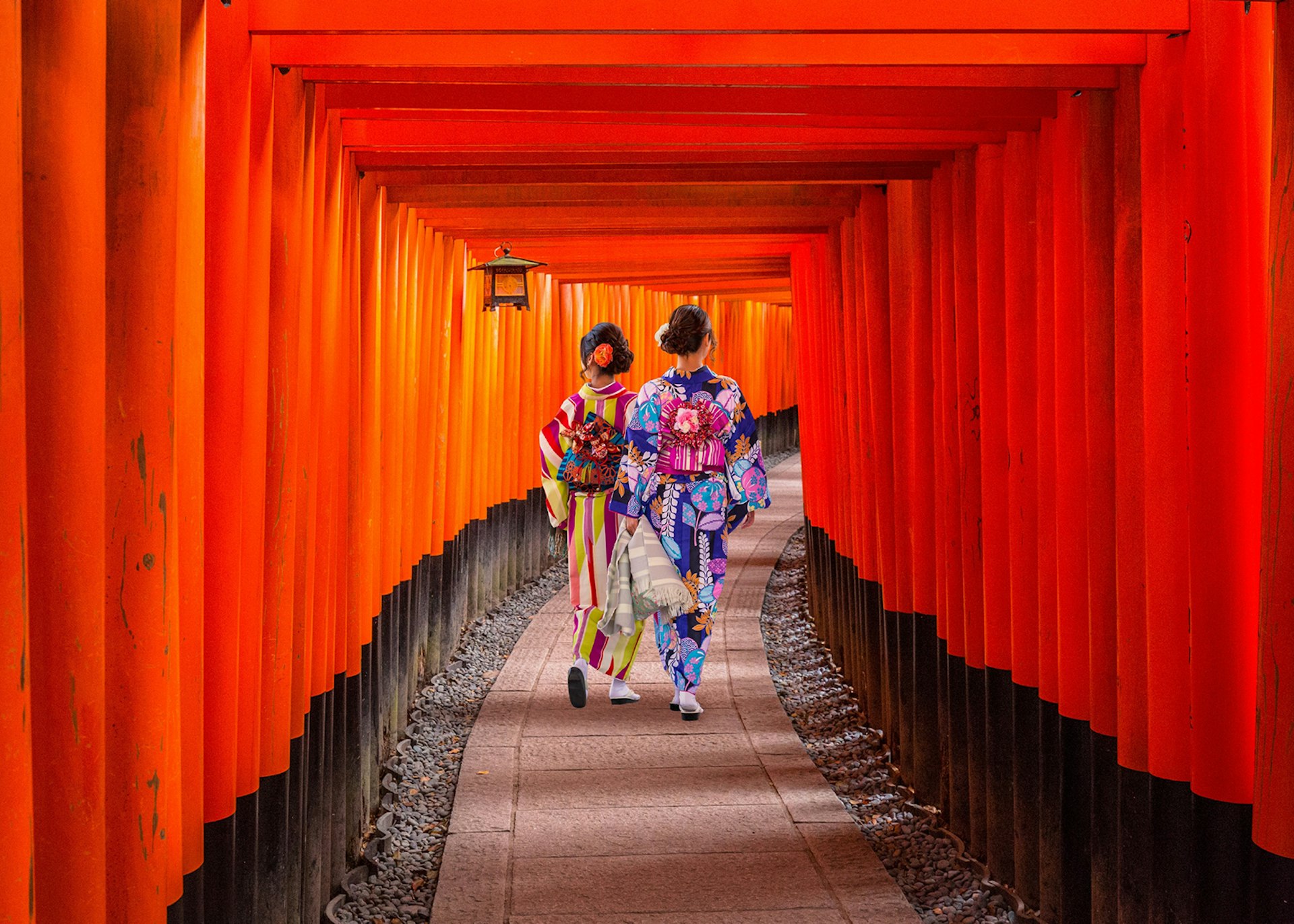 Japanese women in kimonos walking at the Fushimi Inari Shrine in Kyoto, Japan © Patryk Kosmider / Shutterstock