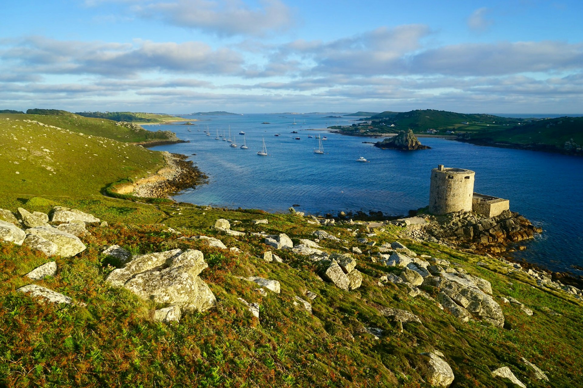 A view of New Grimsby Harbour at sunset from the ruins of King Charles's Castle on Tresco © James Kay / Lonely Planet