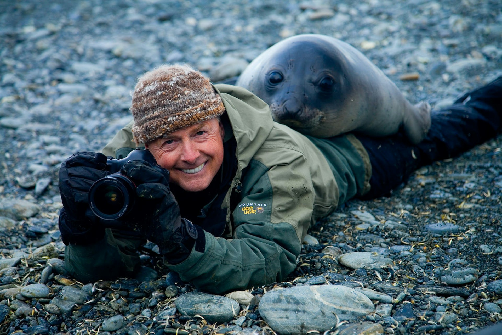 Photographer Art Wolfe and a southern elephant seal during filming for Travels to the Edge on South Georgia Island © Sean White / Art Wolfe