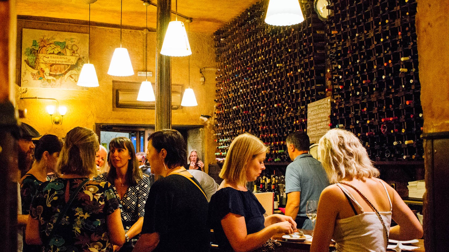 Drinking among wall-to-wall bottles at El Tempranillo © Cassandra Gambill / Lonely Planet