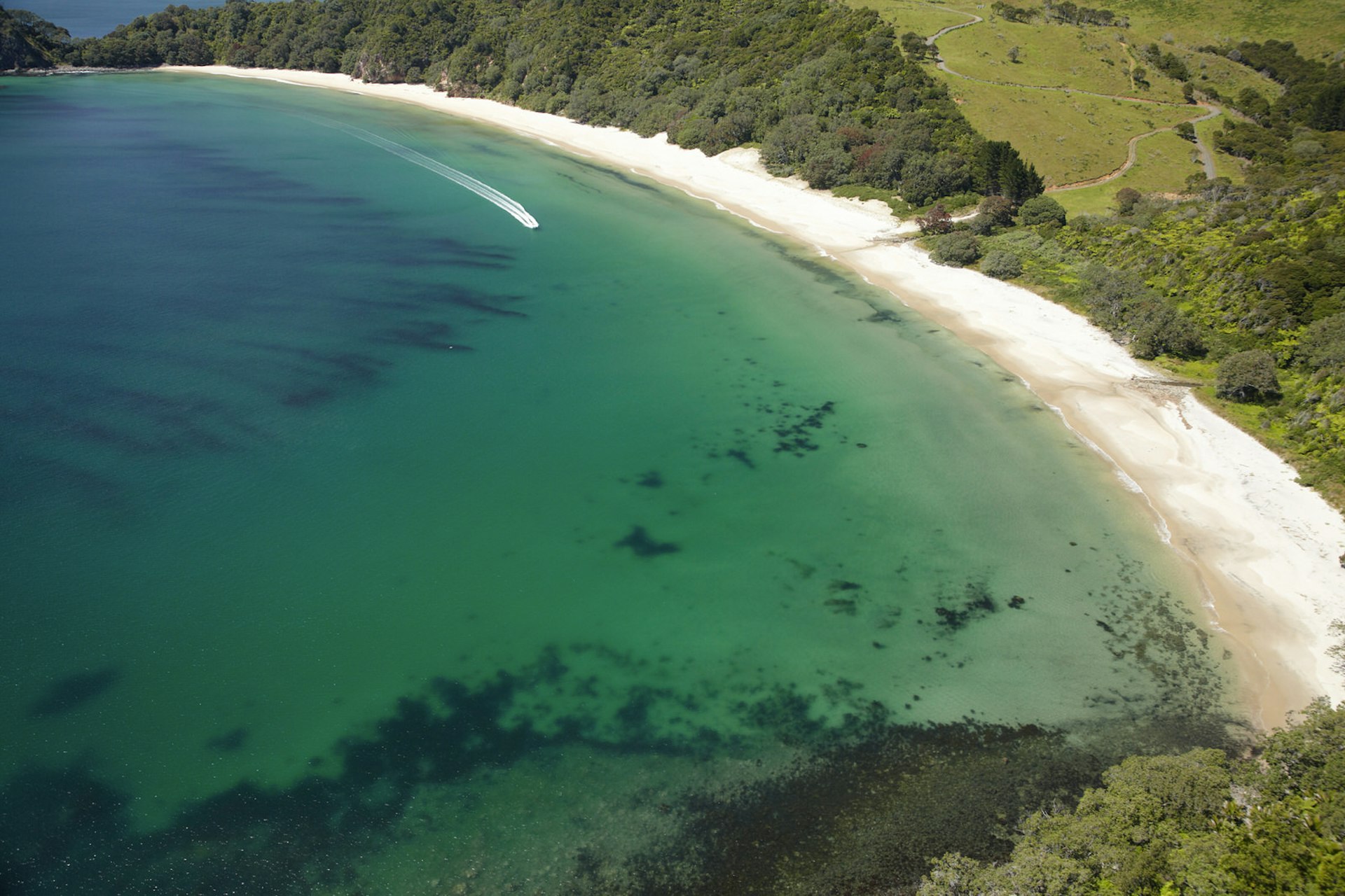 Lesser-known surfing spots – aerial shot of New Chums Beach, New Zealand