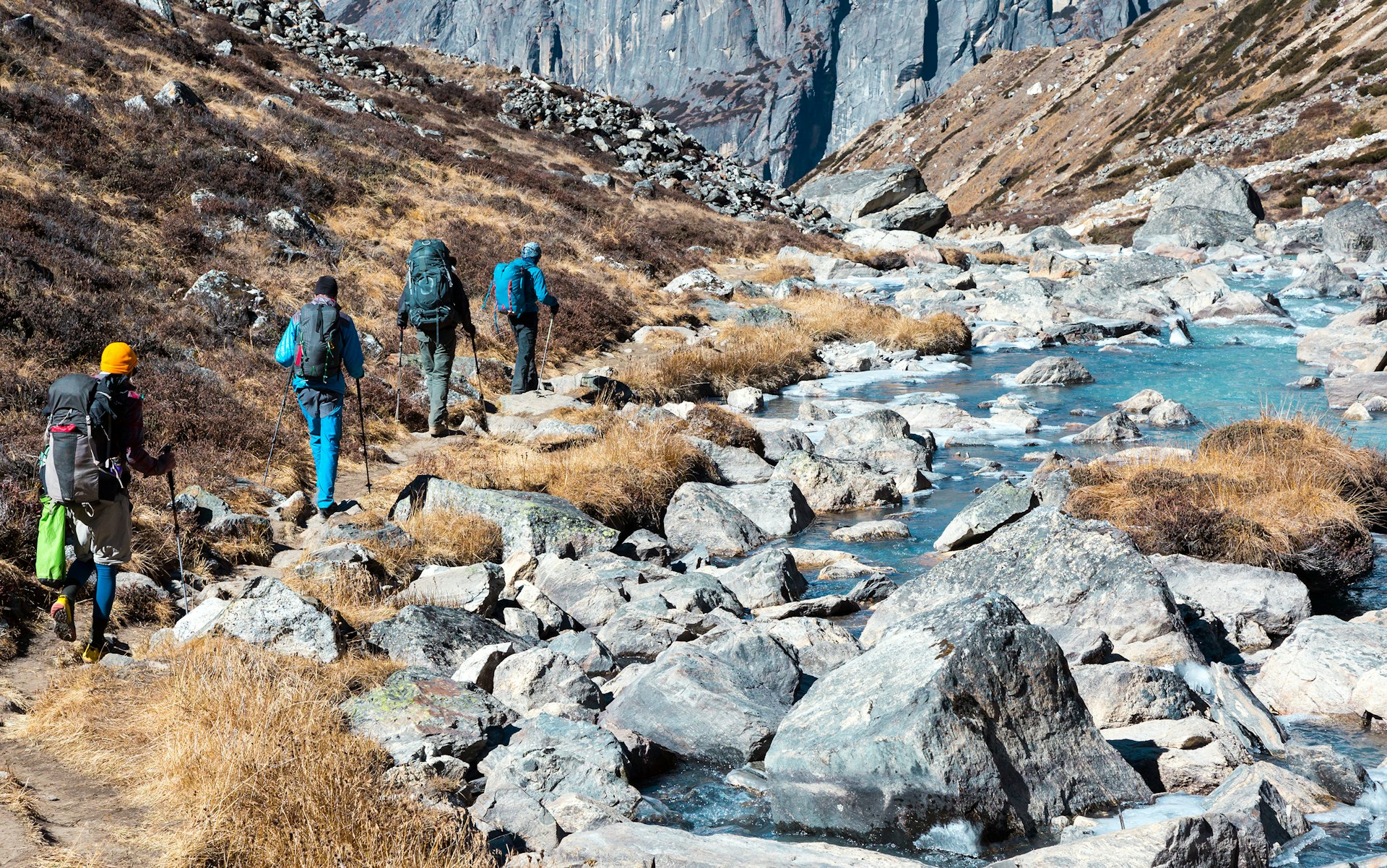 Features - Group of Hikers walking on Footpath in Mountains rear View