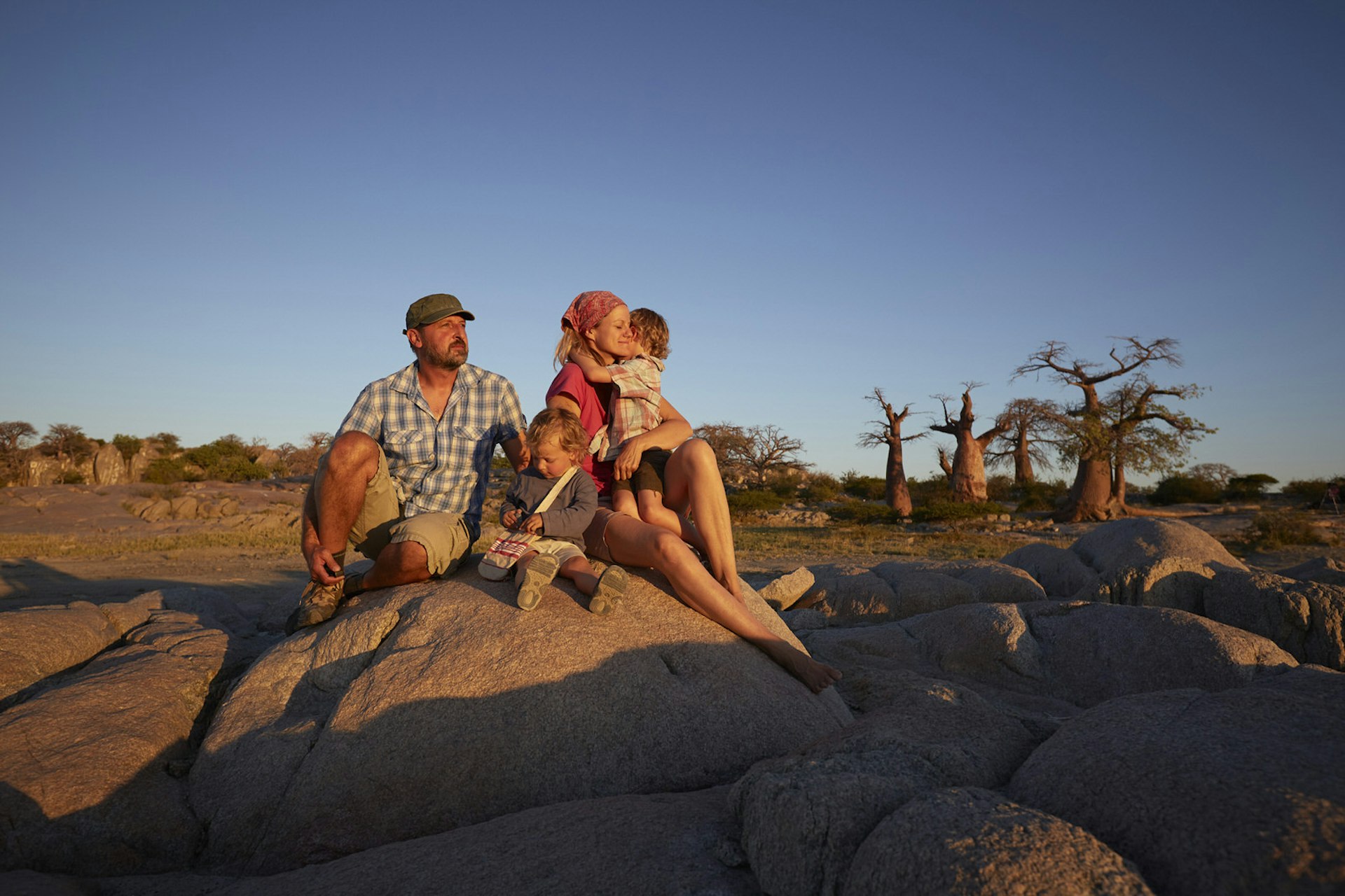 Romantic trip with kids in tow – a family watch the sunset on Kubu Island, Botswana.