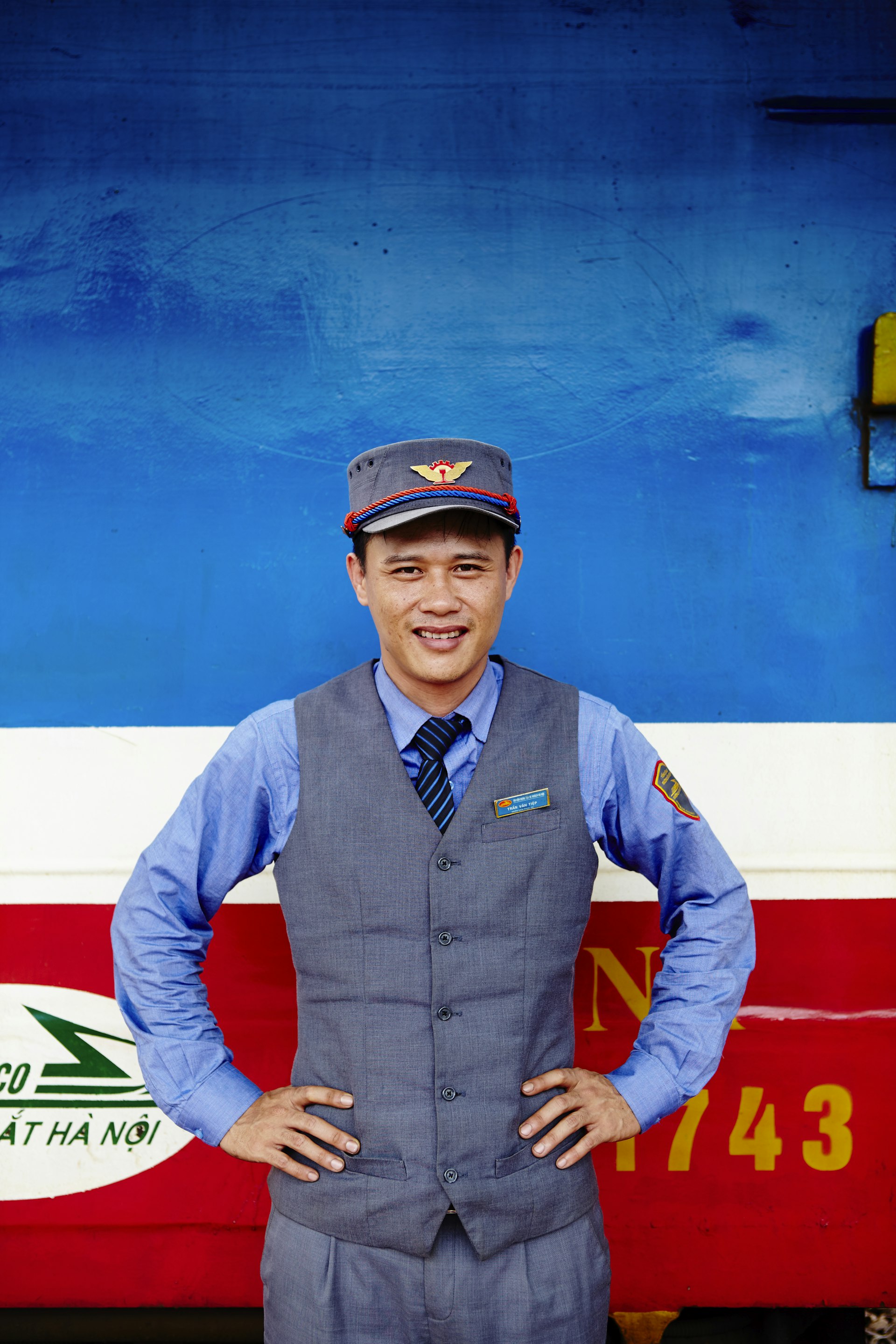 A guard stands in front of a train carriage © Matt Munro / Lonely Planet