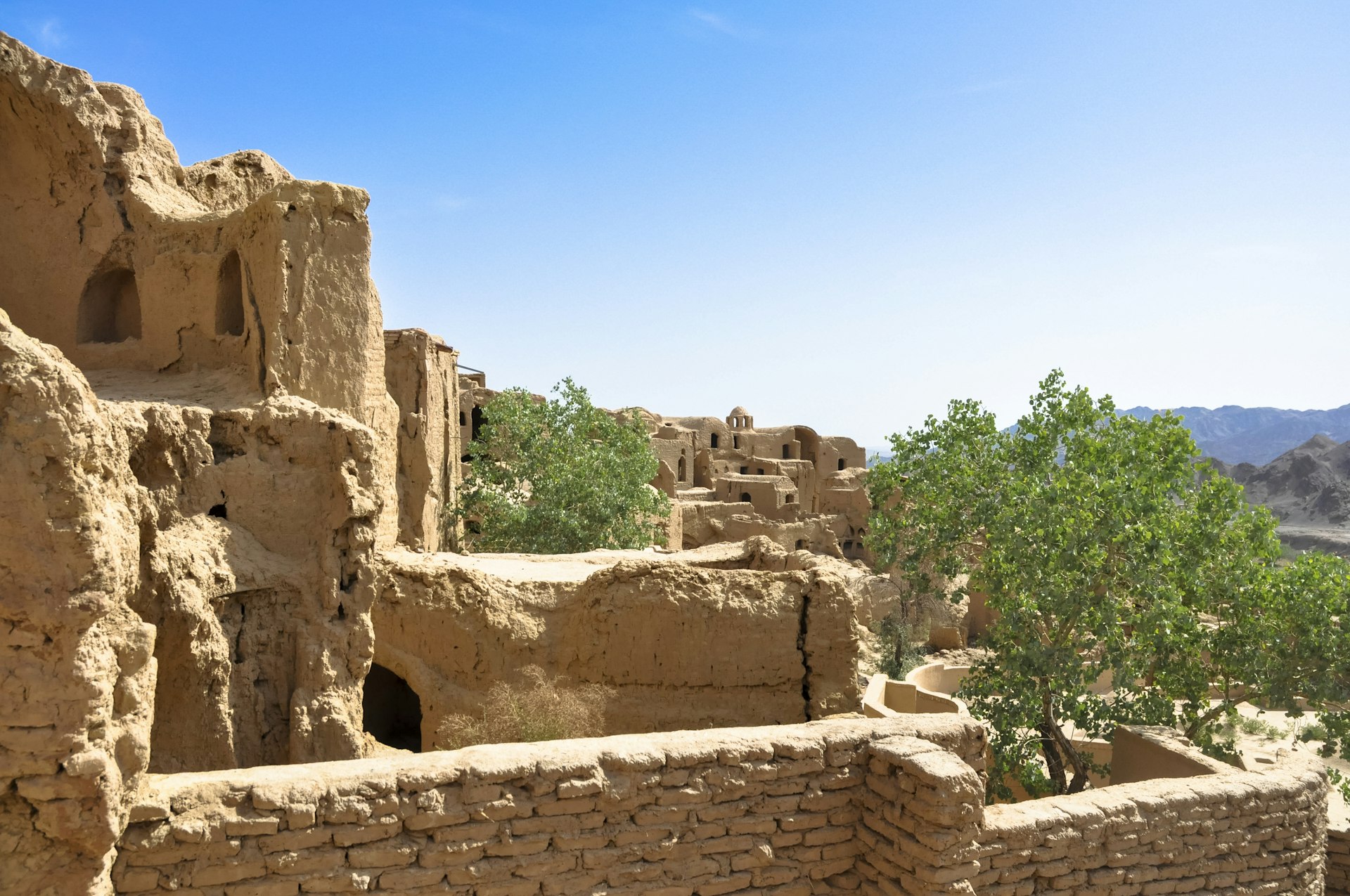 Explore the abandoned mudbrick village of Kharanaq, Iran. Image by Claire Beyer / Lonely Planet