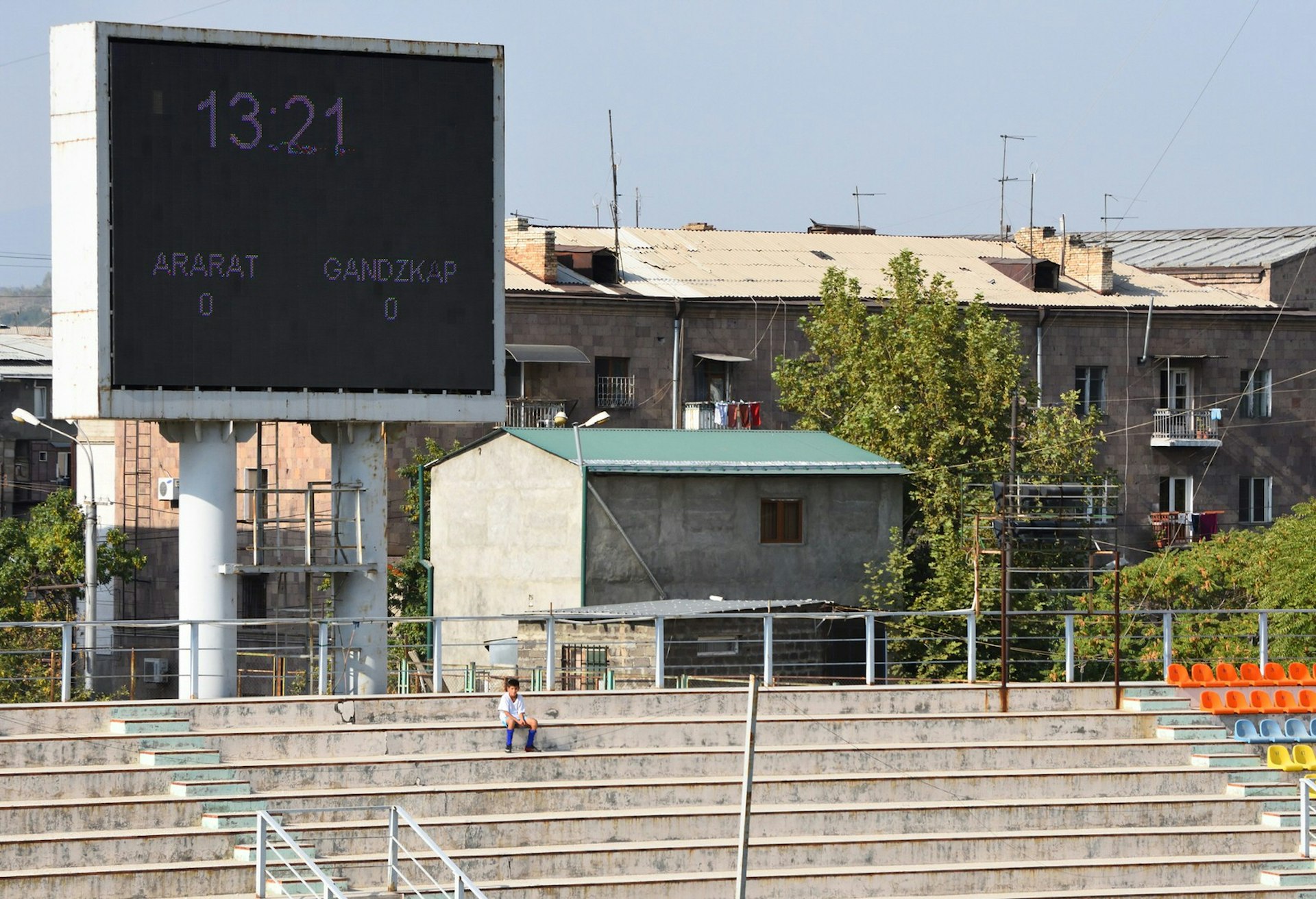 A ballboy sits alone in the stands at Mika Stadium in Armenia © Matt Walker