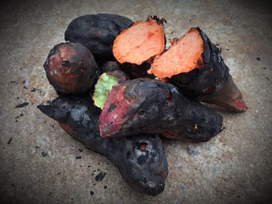 An up-close view of roasted sweet potato on concrete floor; Tokyo