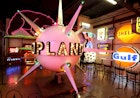 a pink, spiky neon sign takes center stage at the American Sign Museum