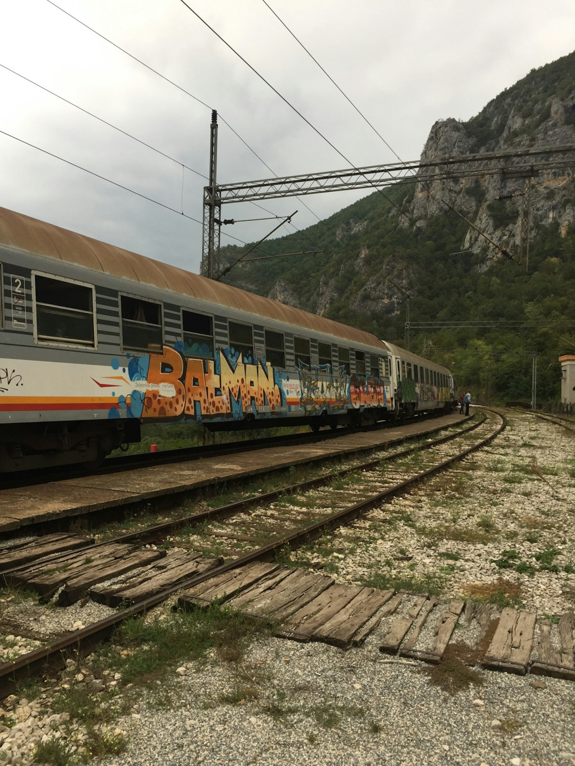 The graffiti-covered carriage at one of the many stops on the Belgrade-Bar railway line