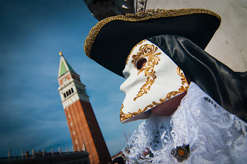 Venice Carnival mask A festival-goer wears a classic Bauta mask. which has space to allow the wearer to eat and chat conveniently.