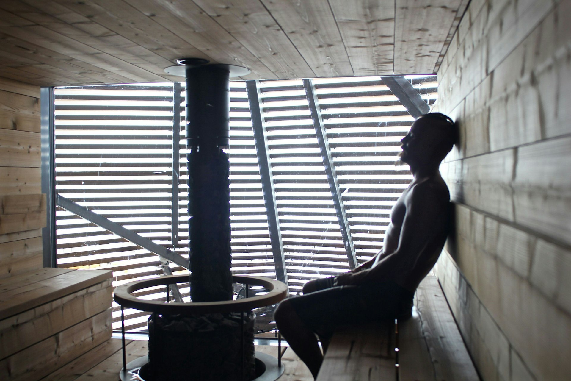 Image of a man sitting inside boutique sauna Loyly in Helsinki.