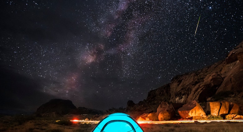 Milky Way, stars and a falling star over a blue tent