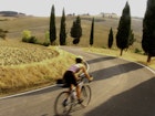 Features - woman bicycling in Tuscany, Italy