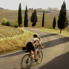 Features - woman bicycling in Tuscany, Italy
