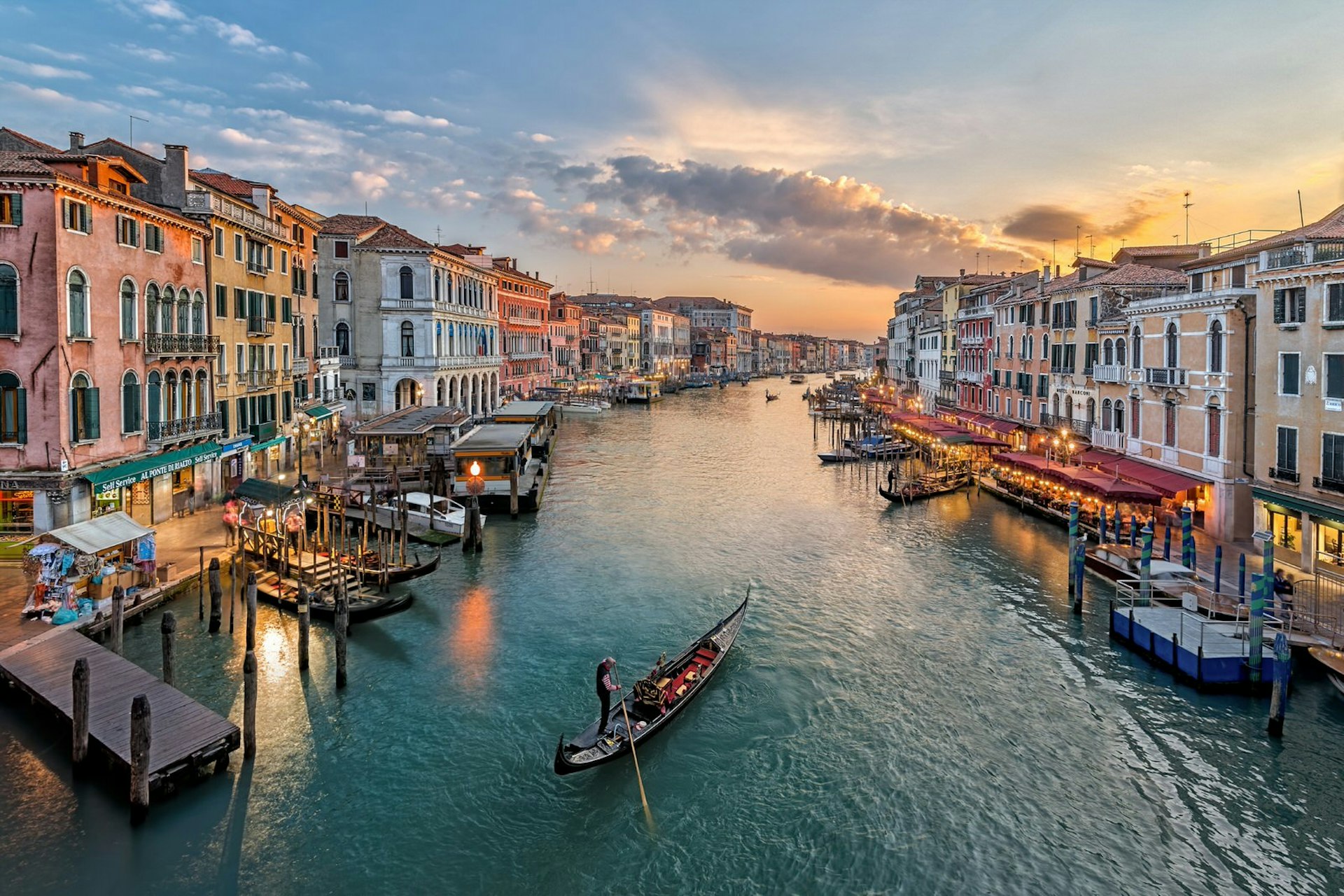 An elevated view of a Venice canal with lone gondola