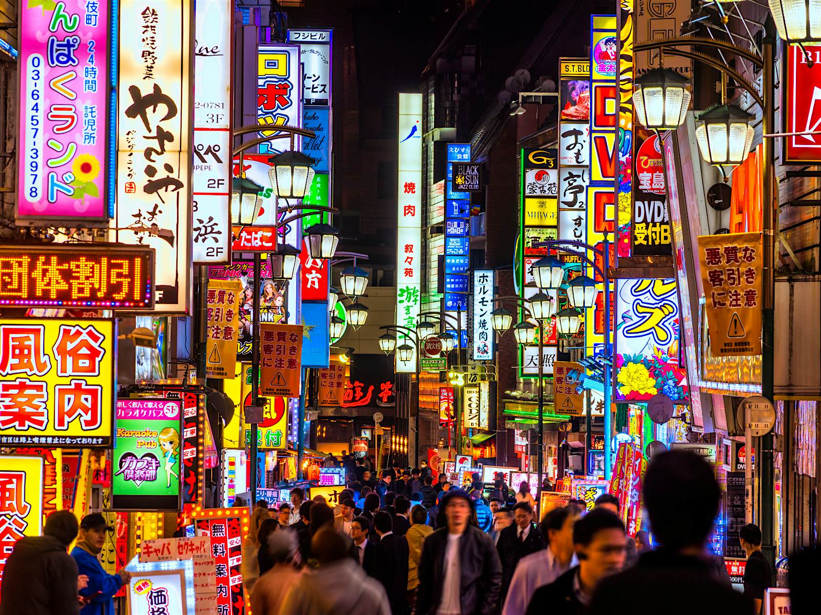 Features - Tokyo_Japan-e38e59e3ecac People walking through the neon-lit streets of Tokyo
