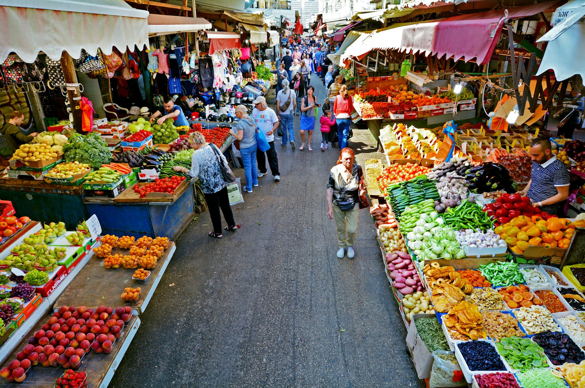 Shoppers at Carmel Market in Tel Aviv, Israel. Image by ChameleonsEye / Shutterstock