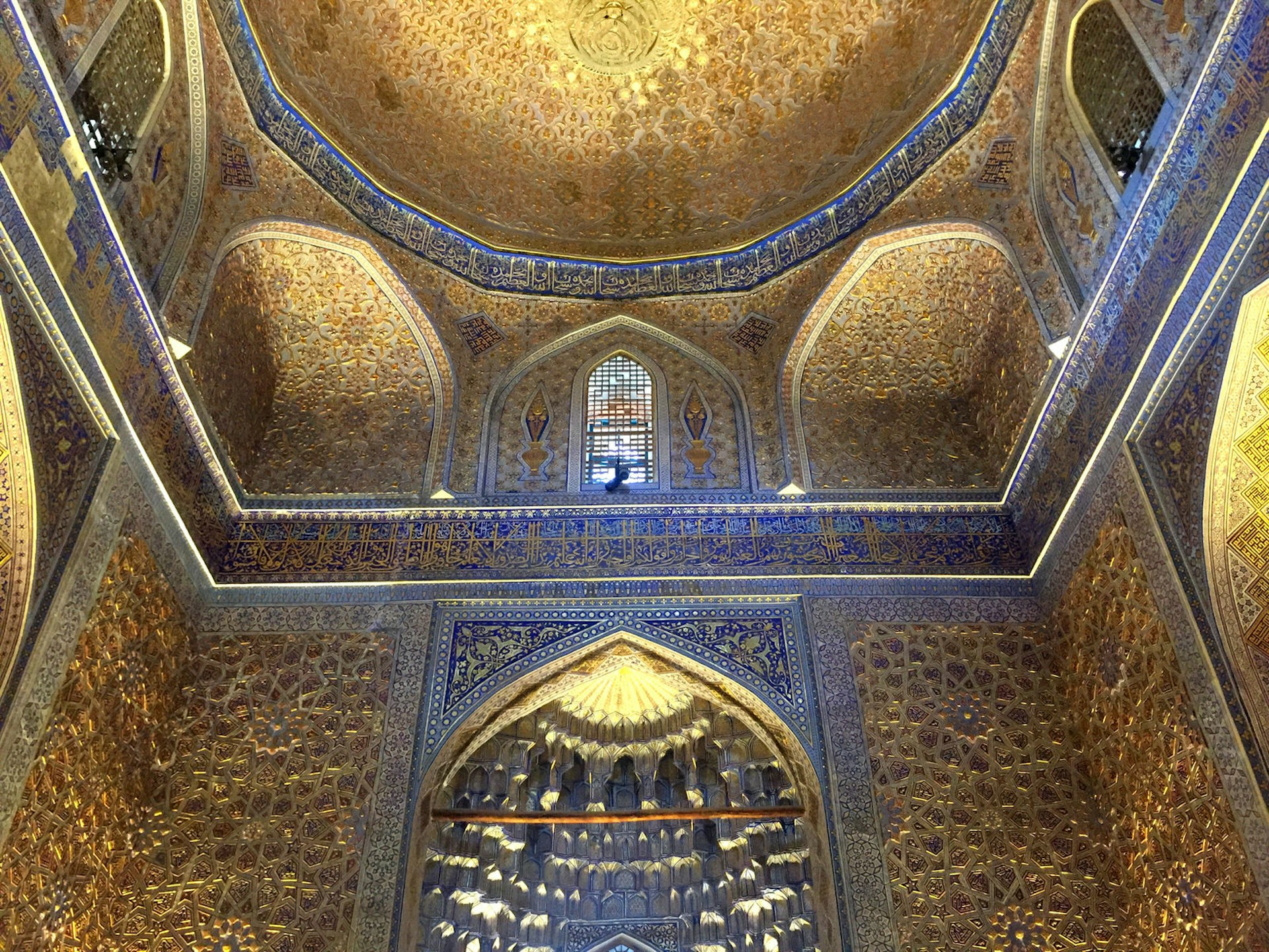 Golden and blue tiles decorate the inside of the vast dome of the Gur-e-Amir