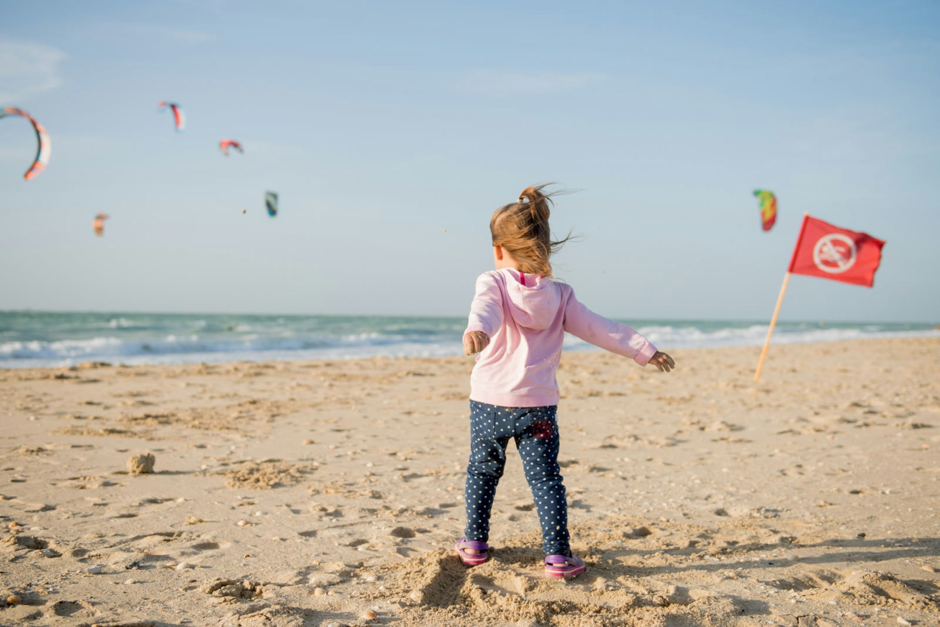 Child playing on Kite Beach, Dubai, United Arab Emirates