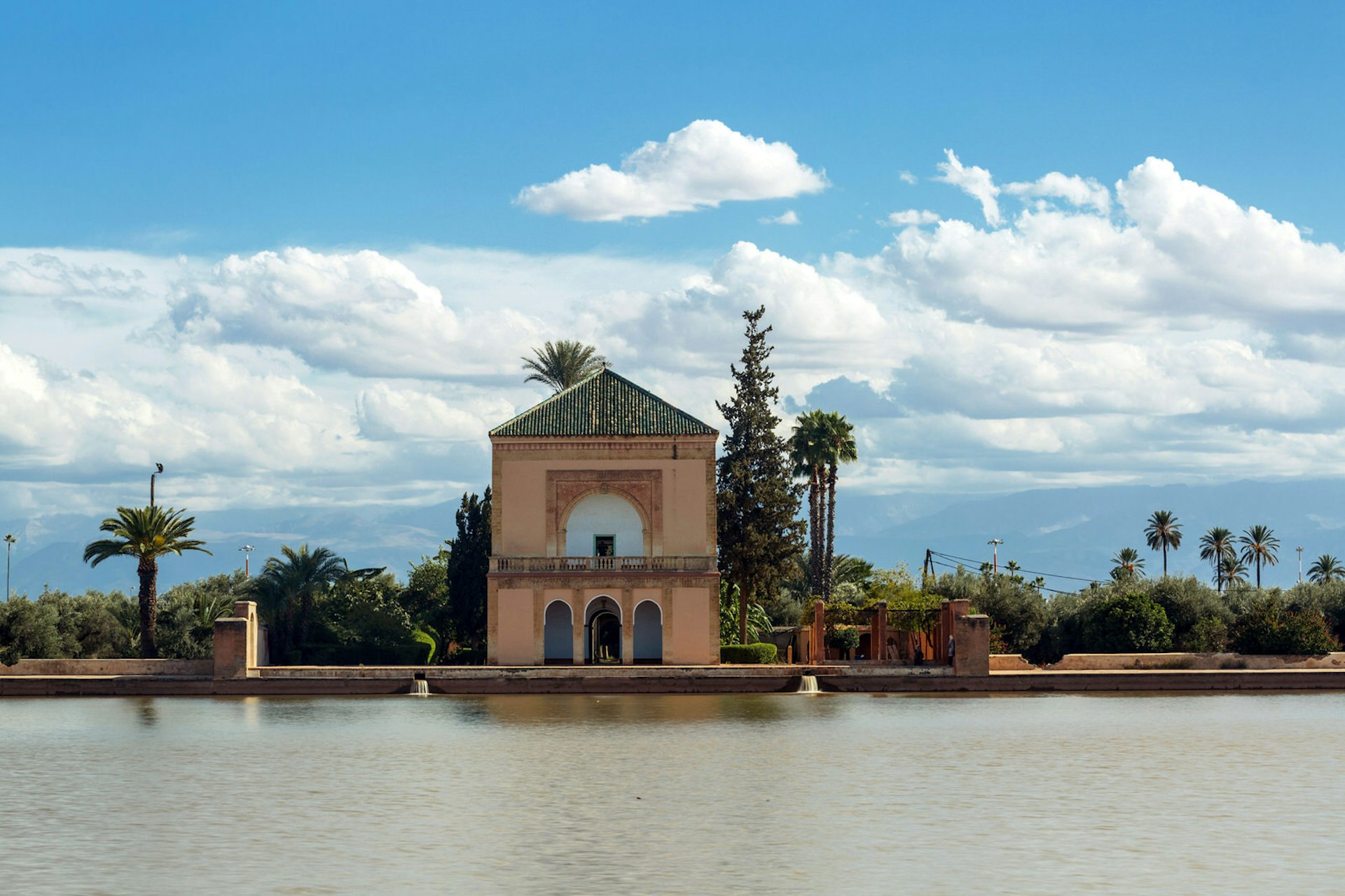 View of the water basin and blue sky at Menara Gardens, Marrakesh, Morocco