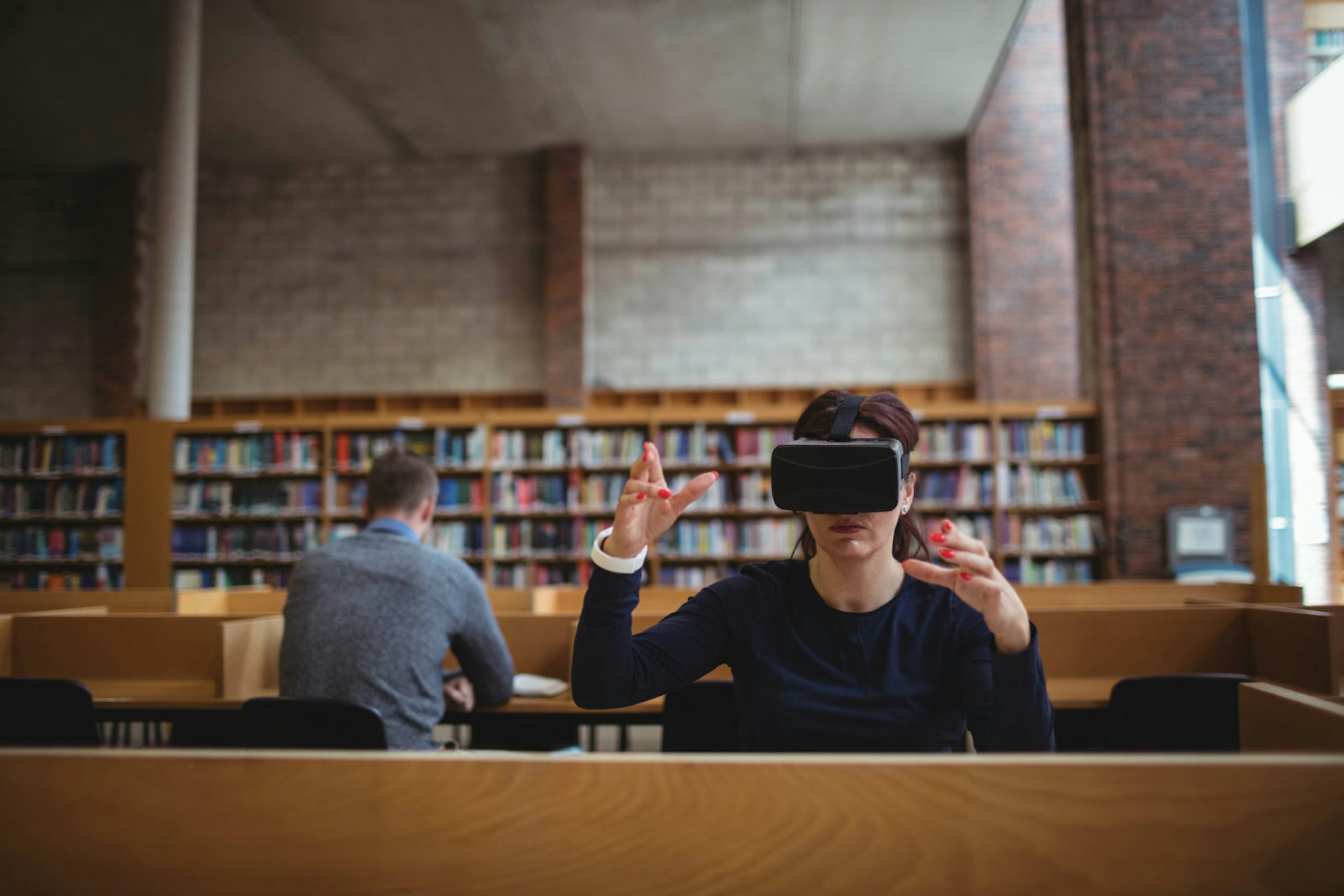 Travel predictions for 2018 - a woman in a library wearing a virtual reality headset © wavebreakmedia / Shutterstock