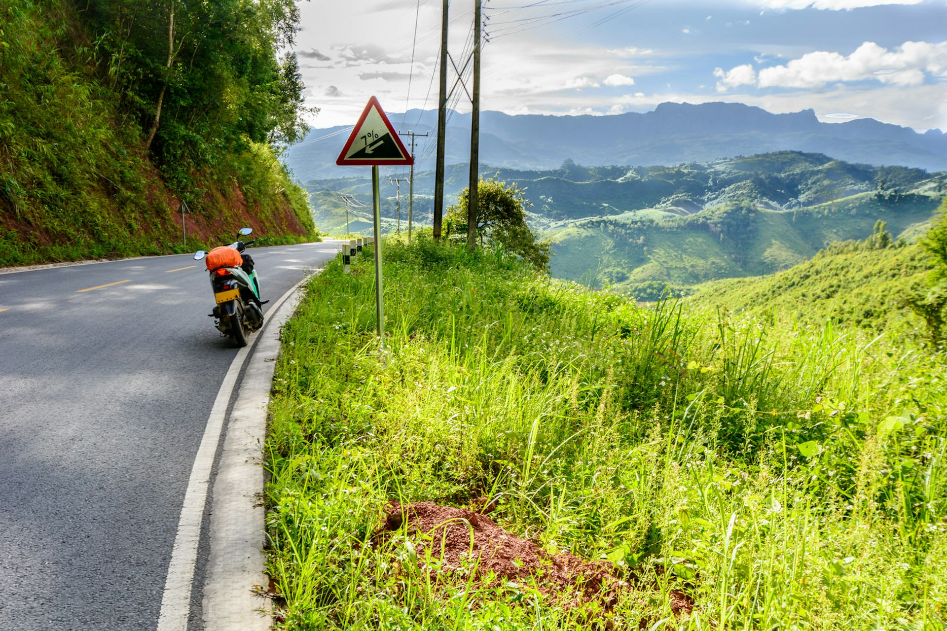 A parked motorcycle on a remote road in northern Laos