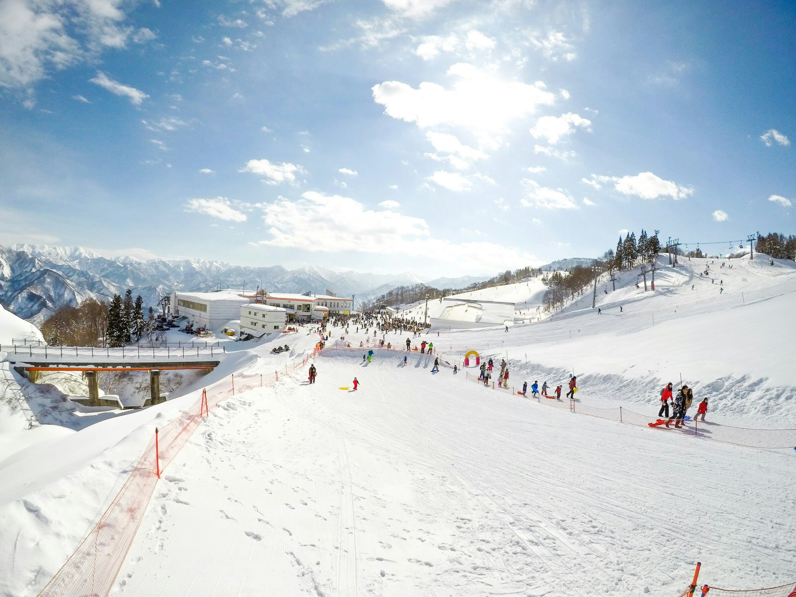 View of skiing on a wide snow-covered ski run on a clear day at Gala Yuzawa ski resort