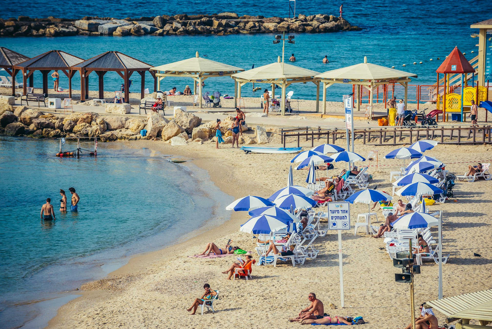 Sunbathers at Hilton Beach, Tel Aviv. Image by Fotokon / Shutterstock