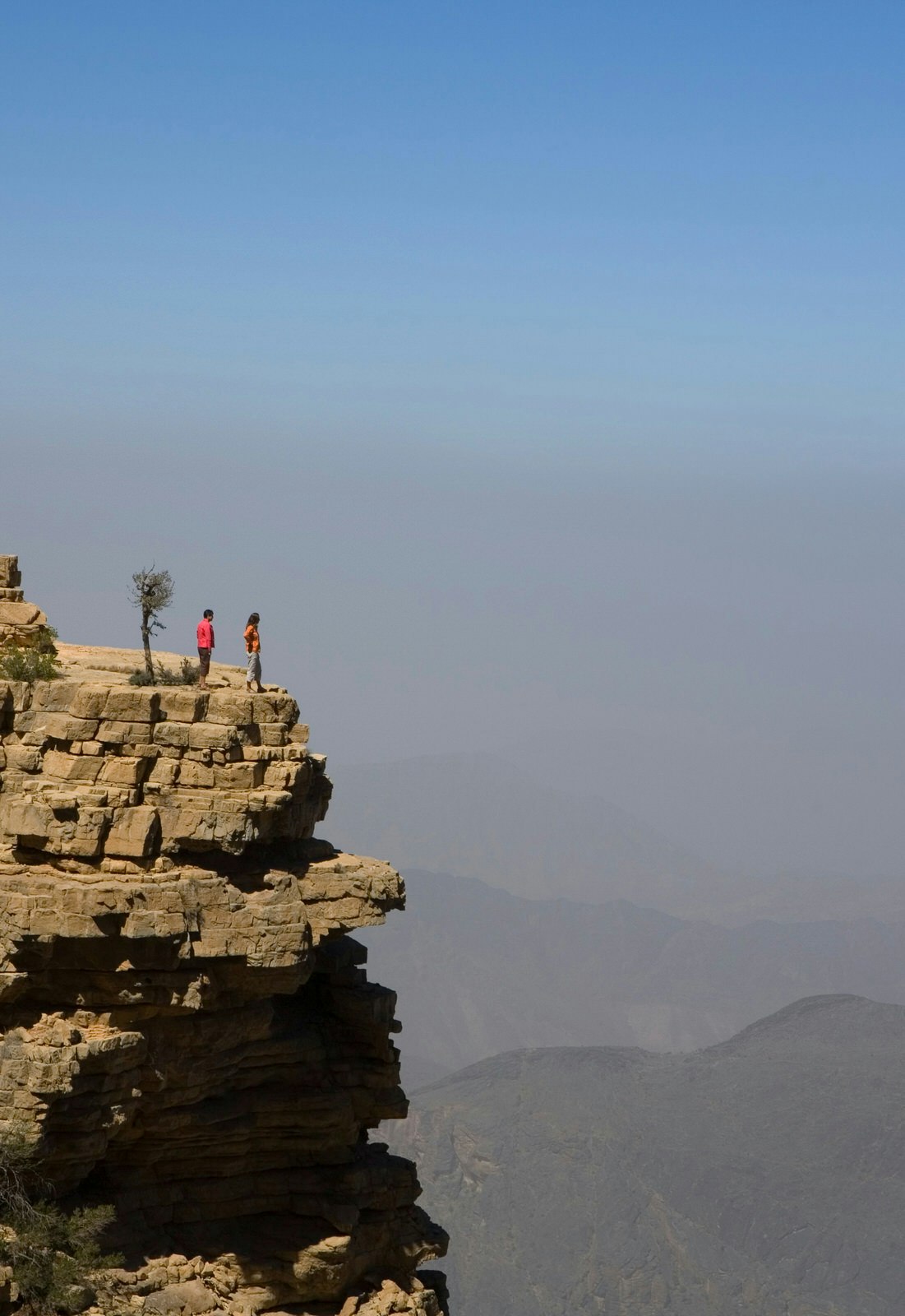 Tourists at a roadside viewpoint in Wadi Bani Awf. Image by Mark Daffey / Getty Images