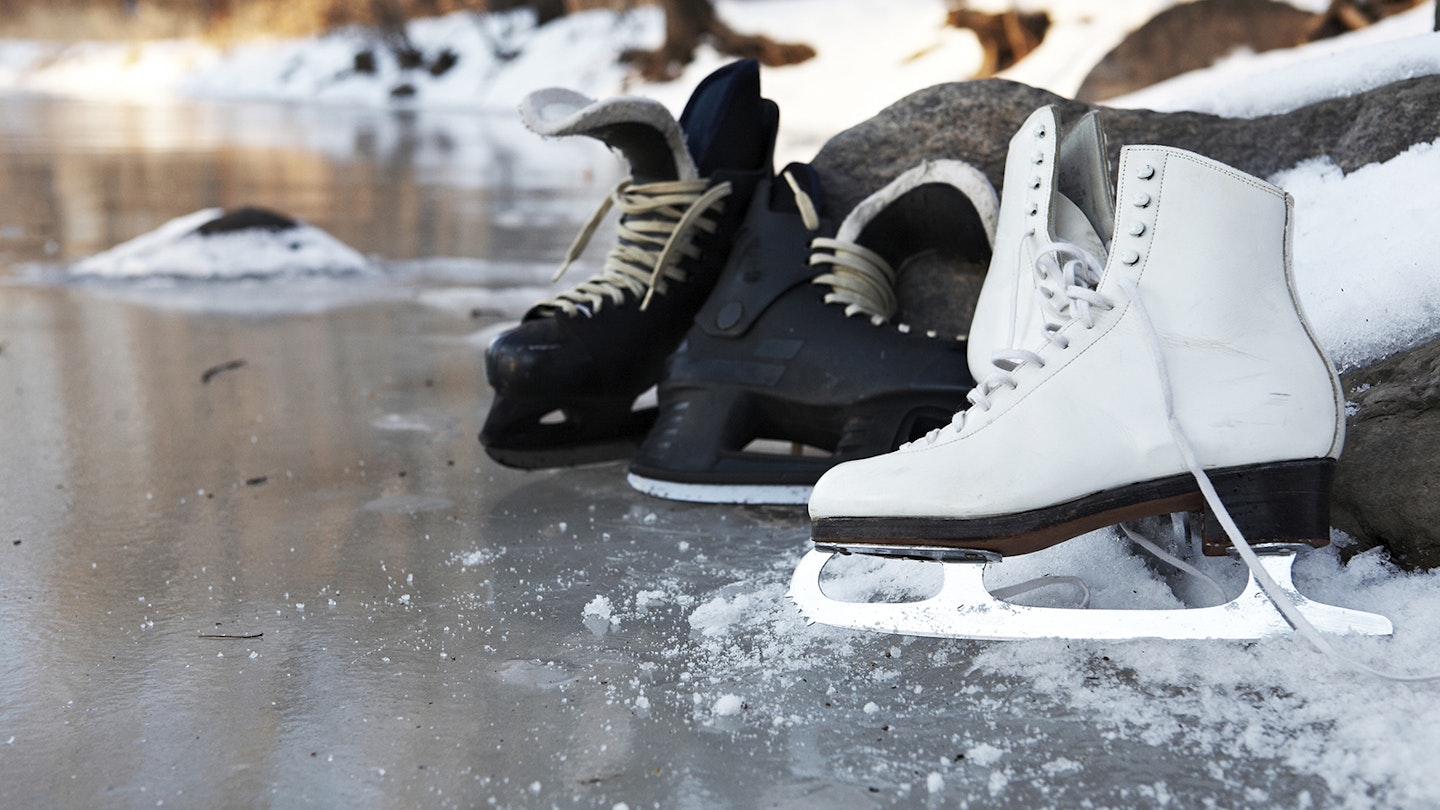 hockey skates and figure skates together on a frozen pond in winter in Minneapolis