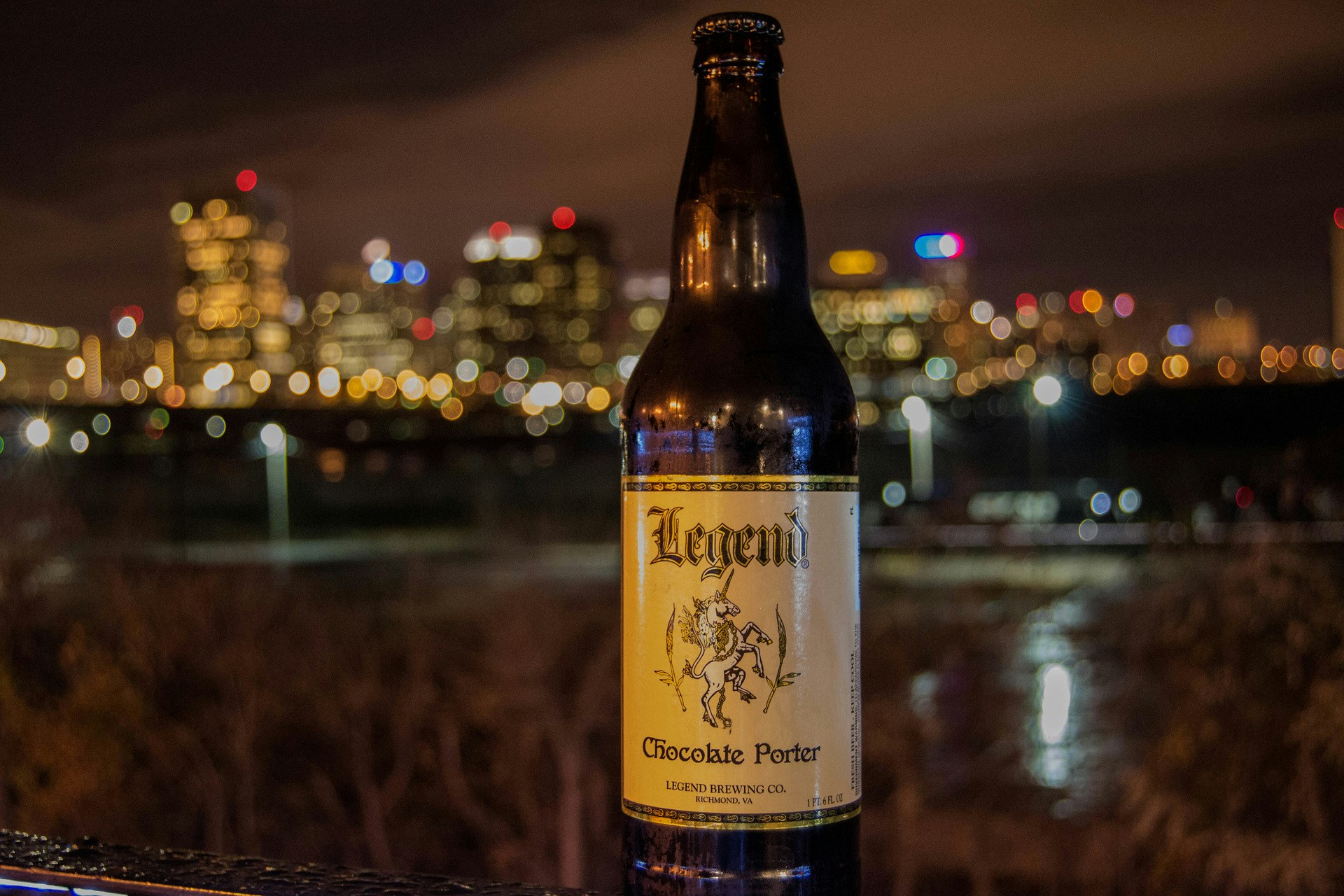 close up of beer bottle with Richmond skyline in background
