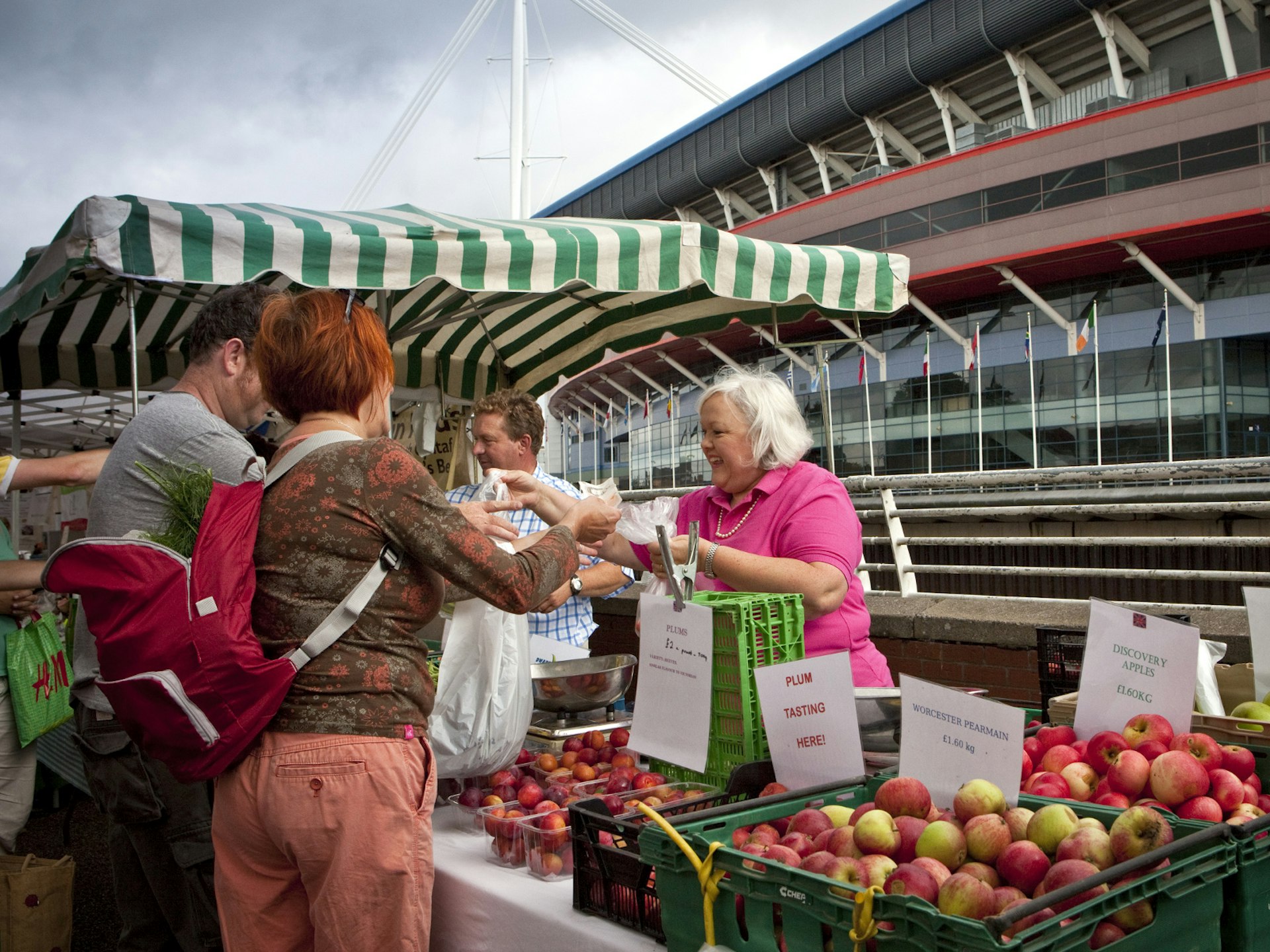 People buying produce from a grocery stand at the Riverside Market, Cardiff © Huw Jones / Getty Images