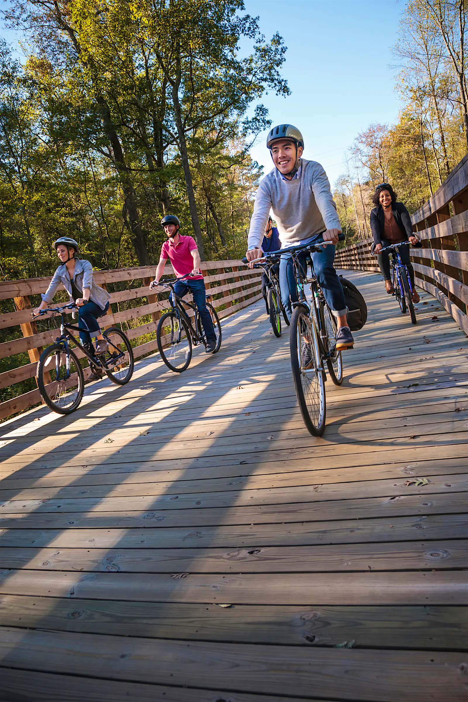 Features - capital_trail_jeff_saxman_web-5eb93f0aaf22 group of cyclists on a boardwalk trail in Richmond Virginia