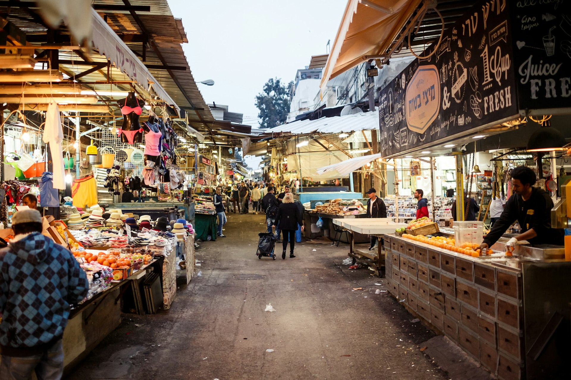 Shoppers at the Carmel Market in Tel Aviv, Israel. It's one of Israel's oldest outdoor marketplaces offers a wide variety of foods and merchandise. Image by Andrey Bayda / Shutterstock