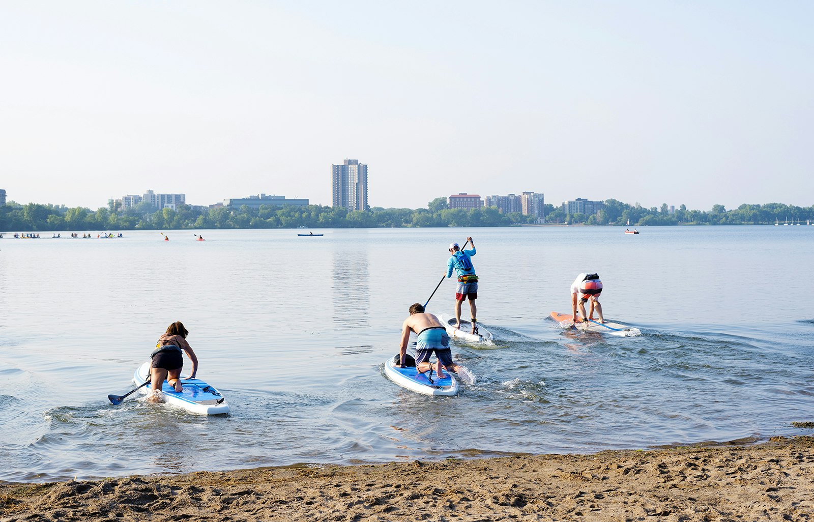 Group of people at start of paddle board race at Lake Calhoun