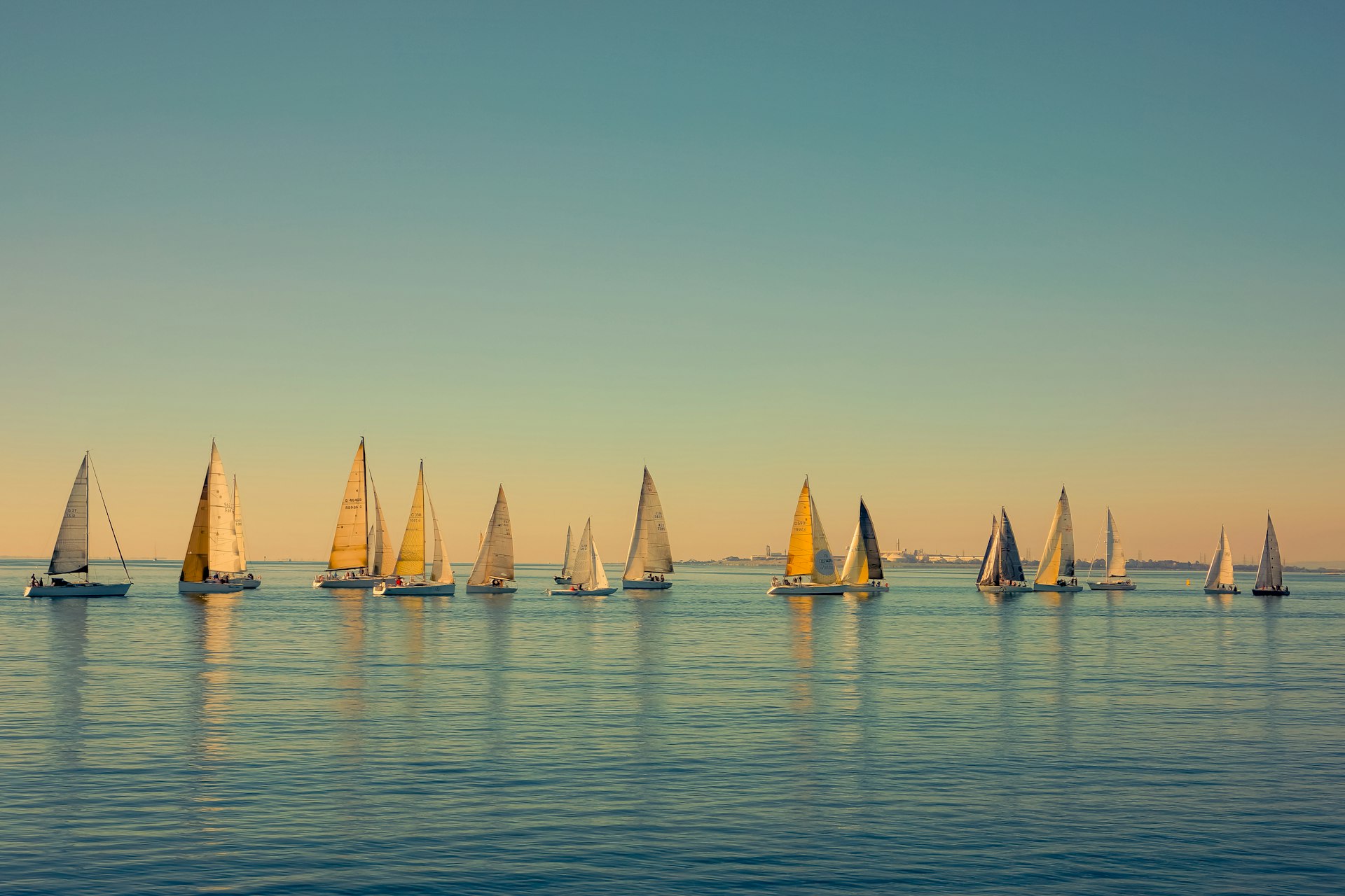 Sailboats scattered on the ocean, seen from The Pier in Geelong, Australia 