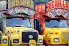 Features - India, South India, Kerala. Painted trucks parked in Cochin.